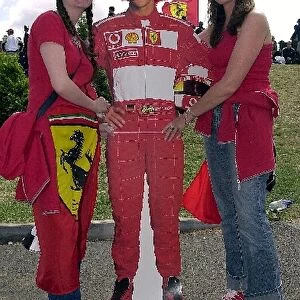 Formula One World Championship: Two Ferrari supporters with a cardboard cut-out of Michael Schumacher Ferrari