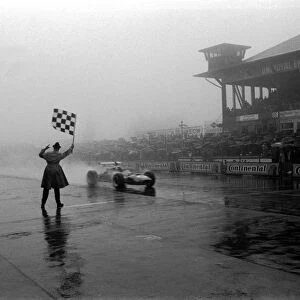 Formula One World Championship: Jackie Stewart Matra MS10 receives the chequered flag and wins arguably his greatest ever race, winning by over