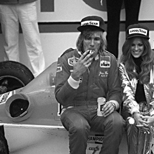 Formula One World Championship: Winner James Hunt Mclaren M26, with victory spoils, cigarette, beer, girl and garland