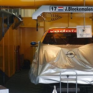 The mechanics of the OPC EuroTeam are still working on the car of Jeroen Bleekemolen