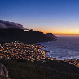 Cape Town Skyline and Camps Bay with clouds over the Twelve Apostles Mountains at dusk, South Africa