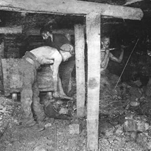 Miners hand digging coal