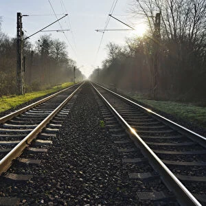 Railroad tracks with Sun, Arheilgen, Darmstadt, Hesse, Germany