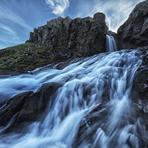 A Small Waterfall Flows Into The Ocean Along The Eastern Coast Of Iceland; Iceland