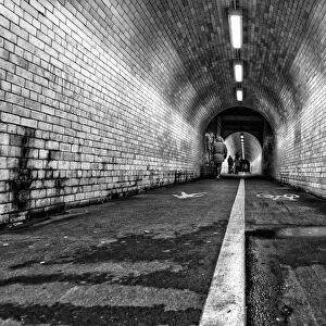 White Line Down The Middle Of A Dirty, Worn Pedestrian And Cycling Tunnel; York, Yorkshire, England