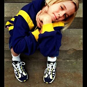 10 year old pop star Aaron Carter May 1998 sitting on steps