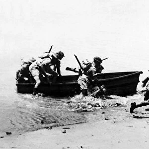 11th Battalion Royal Marines run ashore from a dingy while training in Ceylon