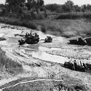 A 17-Pounder anti-tank gun of the 46th Division crosses the ford of River Foglia