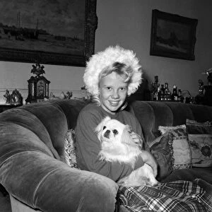 Actress Hayely Mills at home with her pet dog. 31st December 1959