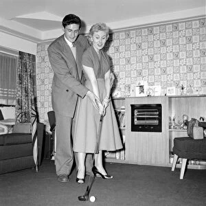 Actress and singer Jill Day seen here getting a golf lesson Circa 1957
