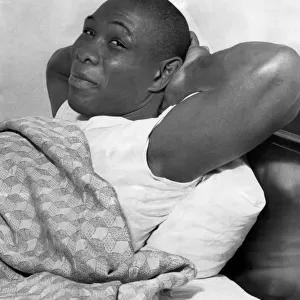 American Boxer Sonny Ray Relaxes in bed at London Cumberland Hotel after his Journey
