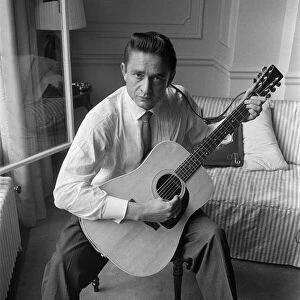 American country singer and musician Johnny Cash poses for photographers at the Savoy