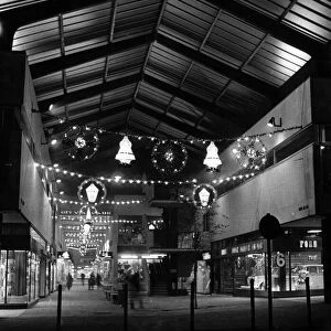 The arched roof of the City Arcade, Coventry, illuminated by the colourful decorations