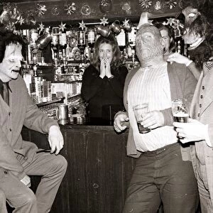 A barmaid is faced with a man dressed as Frankensteins Monster