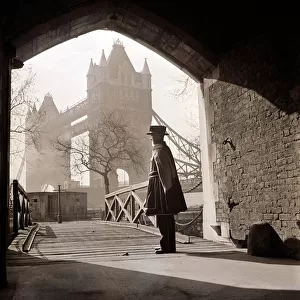 A beefeater guards the entrance to the Tower of London circa 1950s