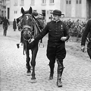 Belgian priest decorated for his bravery is seen here with a cavalry officer following