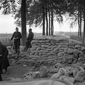 Belgian soldiers and Royal Marines from the Naval Brigade seen here manning a barricade