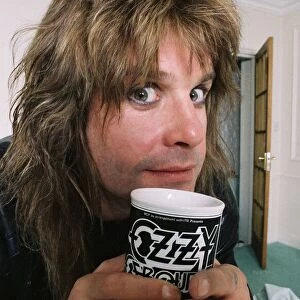 Black Sabbath singer Ozzy Osbourne enjoying a drink form his personalised mug at his home