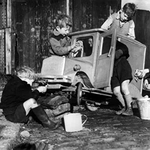 Boys polishing a model van owned by Norman McKeown. 11th November 1952