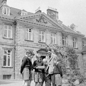Boys talk with the headmaster, Rev. A. R. Duncan-Jones at Bishops Palace, part of St