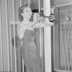 British actress Kay Kendall seen here playing the trumpet. 16th November 1952