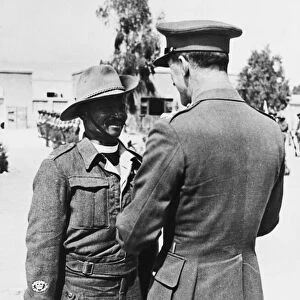 A British Brigadier pins the Africa Star on the breast of an Eswatini padre