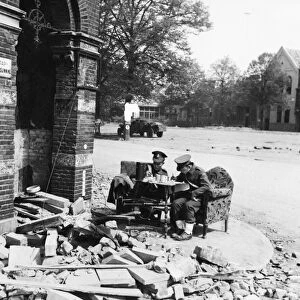British Military Police sit in comfort while checking convoys across the bridge at Arnhem