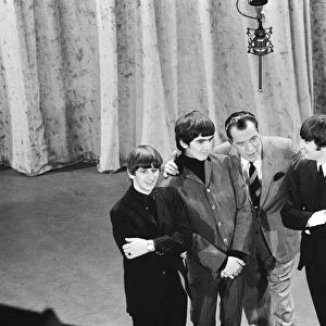 British pop group The Beatles with American talk show host Ed Sullivan on the set of his
