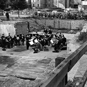 Chelsea holidays at home. London Transport Military Band playing on a bombed site