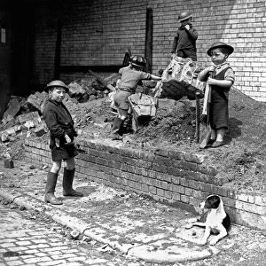 Children play as air raid wardens during the Blitz in London