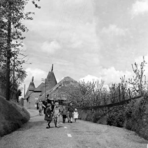 Children walking down a country lane in a typical Kent village