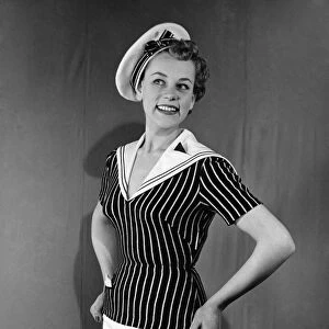 Clothing Beachwear. Model wears sailors hat, striped fitted naval style top