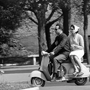 Couple Drive around on a Moped in Rome, Italy