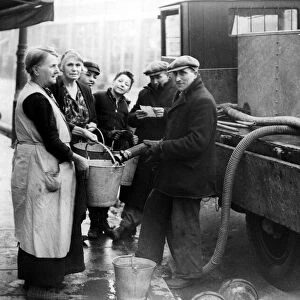 Coventry Corporation workers taking water round to residents that have been bombed