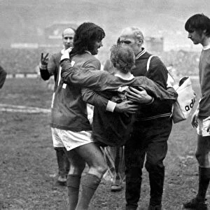 Denis Law of Manchester United being carried off the pitch after an injury