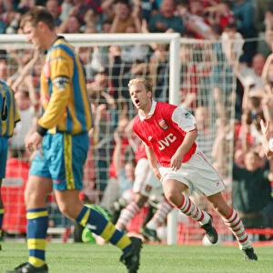 Dennis Bergkamp celebrates his second goal for his new club Arsenal