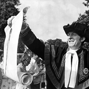Dressed in a black and gold costume, Town Crier Douglas Knott
