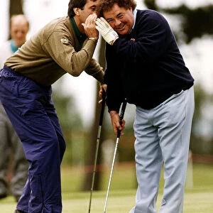 Eddie Little Comedian listens as Sevvy Ballesteros Golf whispers in his ear at a Pro