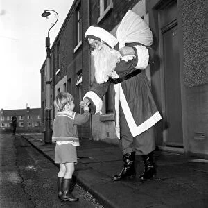 An elderly woman dressed as Santa Claus on her way to an engagement accompanied by