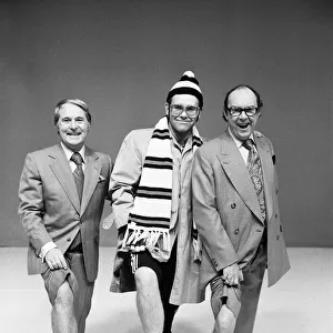 Elton John poses with comedians Ernie Wise (left) and Eric Morecambe as he appears