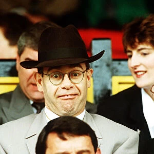 Elton John Singer & Chairman of Watford FC pulls a funny face at Manager Graham Taylor