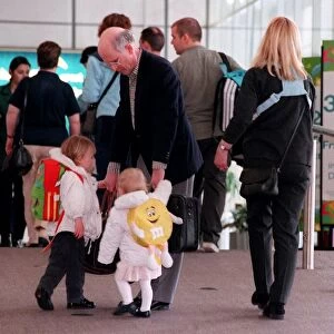 Fergus McCann and family at Glasgow Airport April 1999 taking hold of his