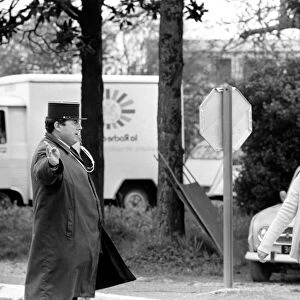 A French Gendarme holds up the traffic as Mrs. Maria Quaranta aged 36