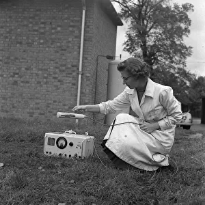 Geiger counter 1958 laboratory assistant using geiger counter A lab assistant