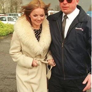 Geri Halliwell Ginger Spice in fur trimmed coat walks to the helicopter as she prepares