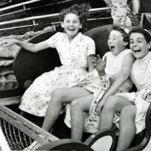 Three girls riding the Caterpillar at Margates Dreamland fun fair
