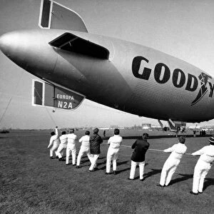 The Goodyear Europa airship is hauled into position by teams of men at RAF Cardington