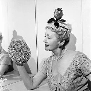Hedda Hopper who is going to present to the Queen two of her fantastic hats