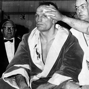 Henry Cooper having his wounds attended to in dressing room May 1966 after the World