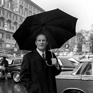 Henry Cooper in Italy: Henry Cooper pictured in the rain on the Via Veneto